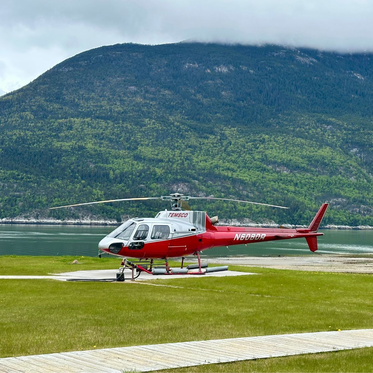 Red helicopter with mountains behind