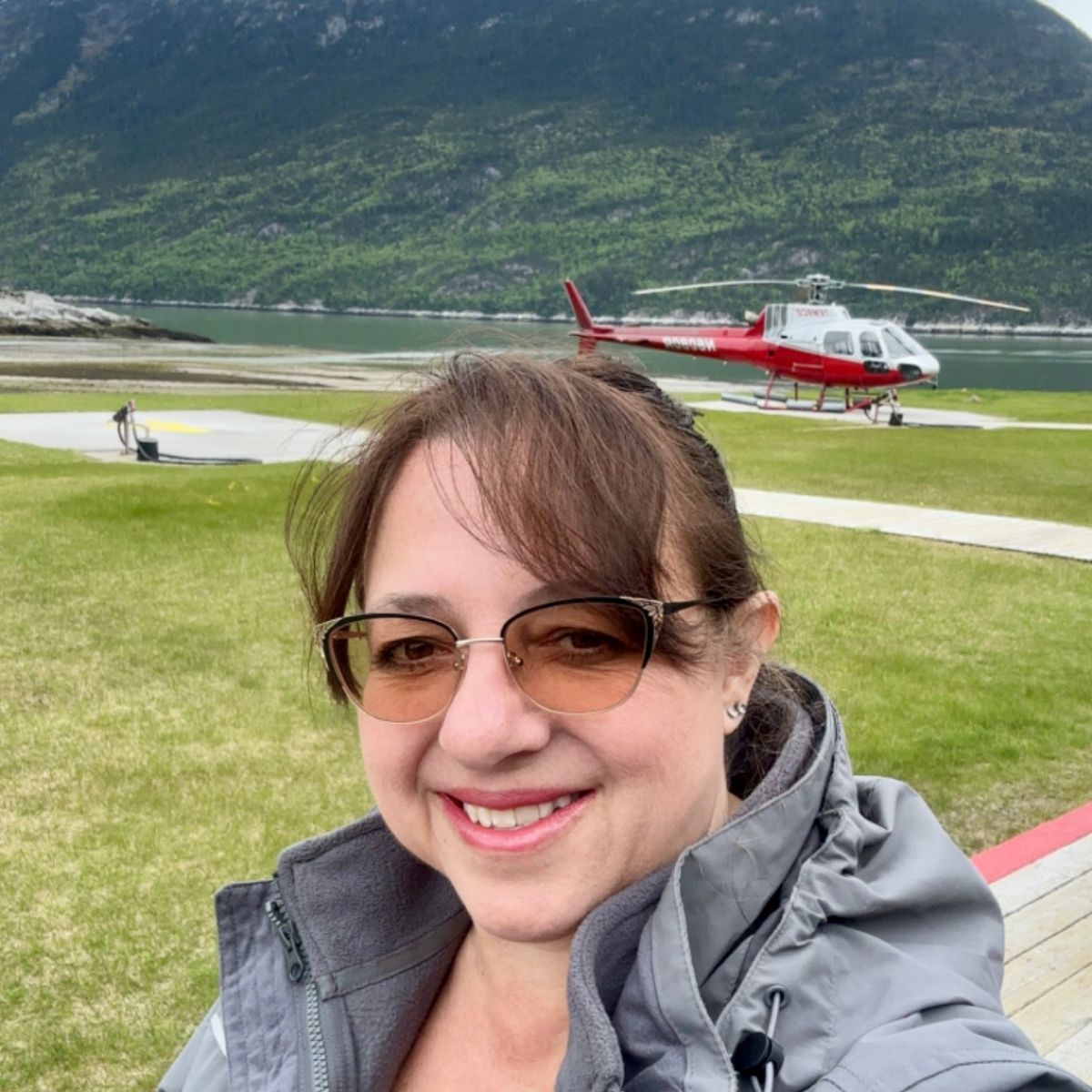 Red helicopter with mountains behind